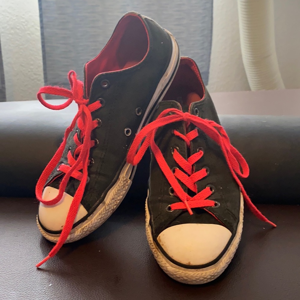 Black and pink converse with design on tongue